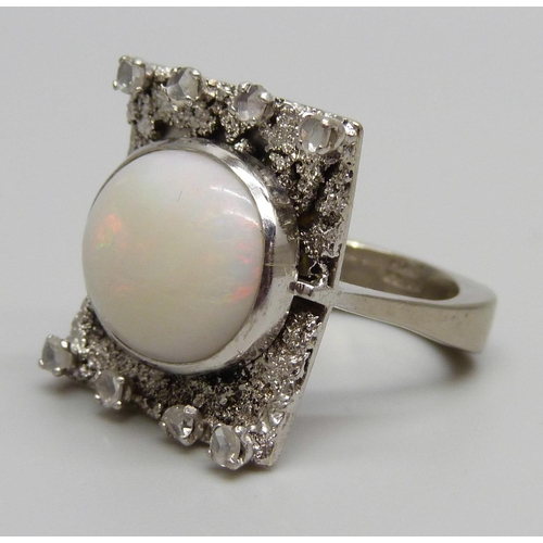 880A - A 9ct white gold Brutalist style ring set with eight old cut diamonds and a large opal, Birmingham 1... 