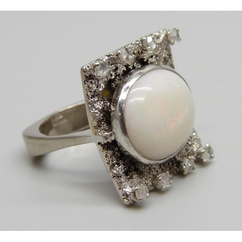 880A - A 9ct white gold Brutalist style ring set with eight old cut diamonds and a large opal, Birmingham 1... 