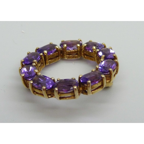 883 - A yellow metal and amethyst set brooch, indecipherable ct stamp, 4.8g, 2.4cm