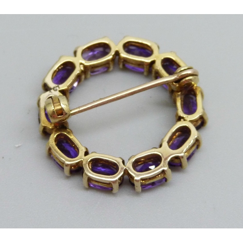 883 - A yellow metal and amethyst set brooch, indecipherable ct stamp, 4.8g, 2.4cm