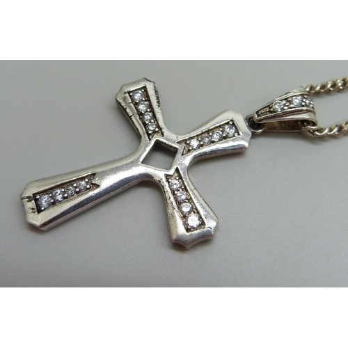 886 - A large silver and cubic zirconia cross pendant on a silver chain, 30g