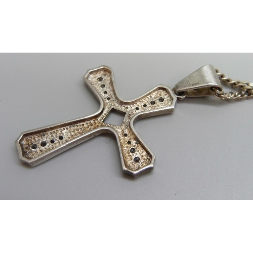 886 - A large silver and cubic zirconia cross pendant on a silver chain, 30g