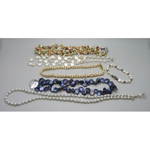 887 - A collection of pearl necklaces including two silver mounted, and a faux pearl glasses chain