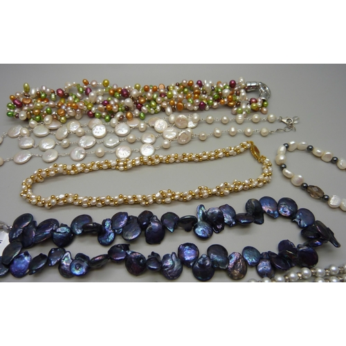 887 - A collection of pearl necklaces including two silver mounted, and a faux pearl glasses chain