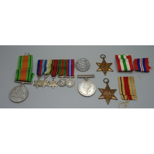 942 - A group of WWII medals, miniatures and a German badge