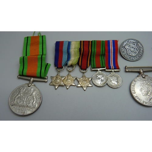 942 - A group of WWII medals, miniatures and a German badge