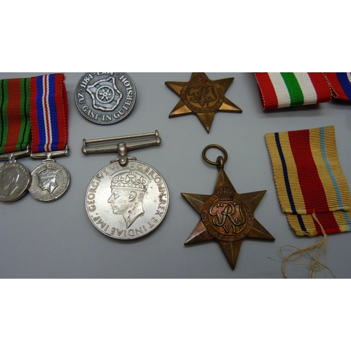 942 - A group of WWII medals, miniatures and a German badge