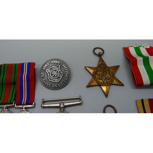 942 - A group of WWII medals, miniatures and a German badge