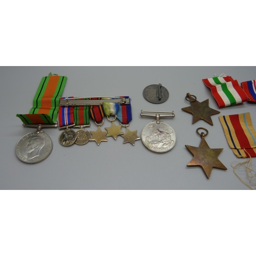 942 - A group of WWII medals, miniatures and a German badge