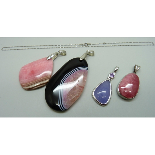 957 - Two silver stone pendants, a silver chain, and two larger plated pendants