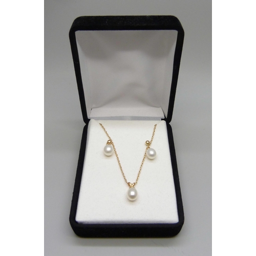 961 - A fine 9ct gold chain with a yellow metal set pearl pendant, and a pair of yellow metal and pearl ea... 