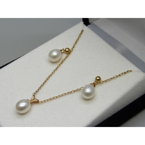 961 - A fine 9ct gold chain with a yellow metal set pearl pendant, and a pair of yellow metal and pearl ea... 