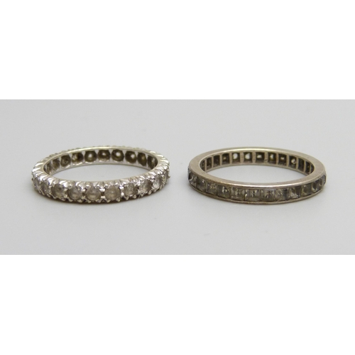 976 - Two white metal eternity rings, both size N, one marked 9ct, 3.7g total