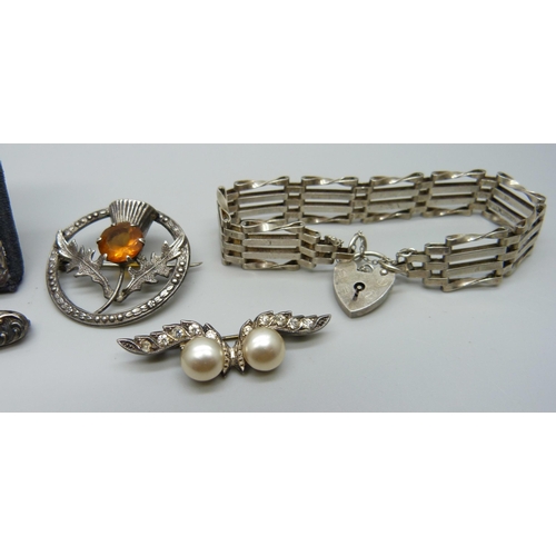 990 - A miniature Silver photograph frame, a silver gate bracelet and three silver brooches (faux pearl br... 