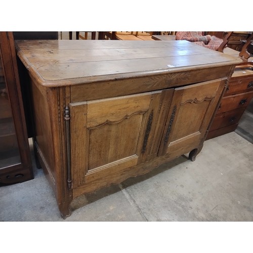 173 - An 18th Century style French Breton carved oak sideboard