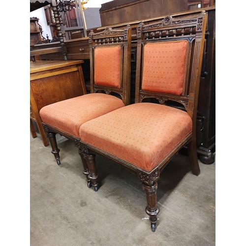 175 - A pair of Victorian carved oak and fabric upholstered dining chairs