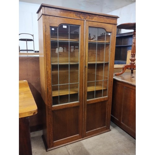 176 - An early 20th century carved oak two door bookcase