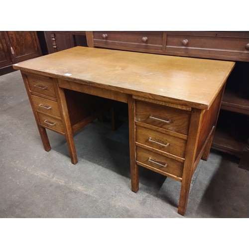 191 - An early 20th Century oak six drawer desk