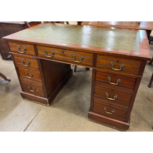 164 - A Victorian walnut and green leather topped pedestal desk