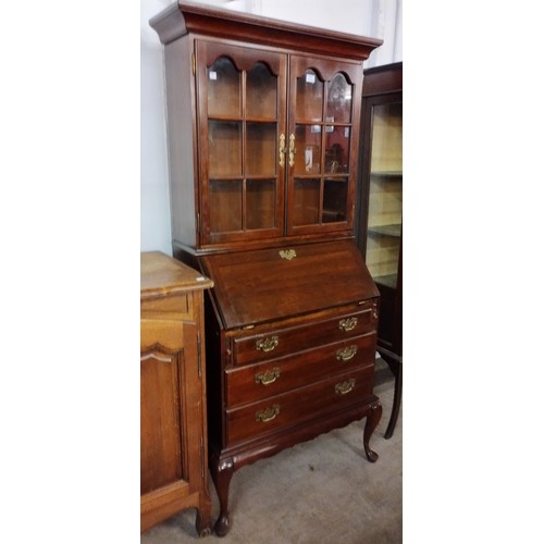 121 - A George III style mahogany bureau bookcase