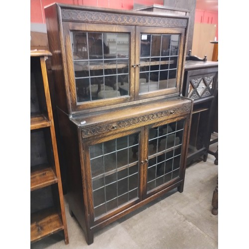 131 - An early 20th Century carved oak four door bookcase