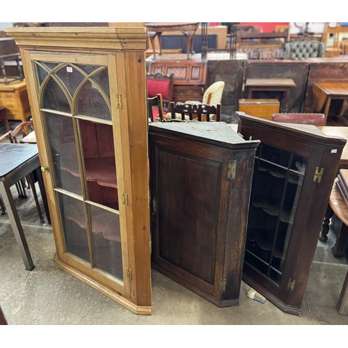 235 - Two George III oak wall hanging corner cupboards and a pine corner cupboard