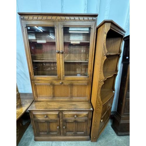 256 - An Ercol Golden Dawn elm bookcase and a freestanding corner cupboard