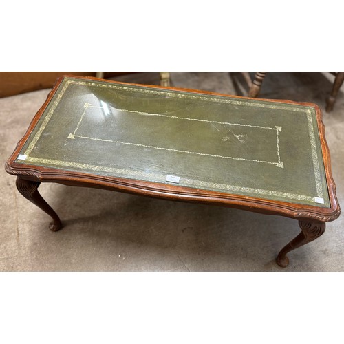 240 - A mahogany and green leather topped coffee table