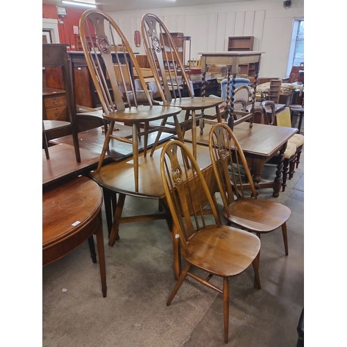 201 - An Ercol Golden Dawn elm drop-leaf table and four swan back chairs