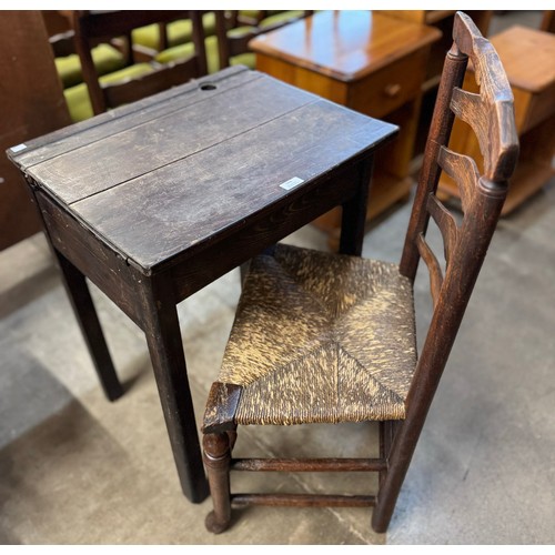 244 - A Victorian beech school desk and a George III elm ladderback chair