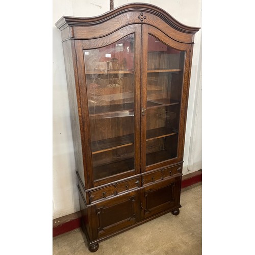 87 - An early 20th Century Jacobean Revival oak geometric moulded bookcase