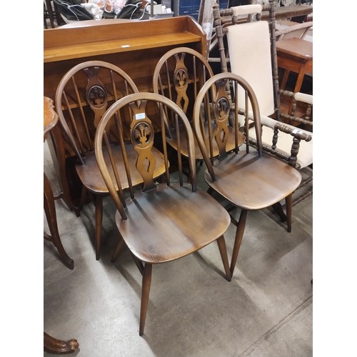 214 - A set of four Ercol Golden elm and beech fleur de lys chairs