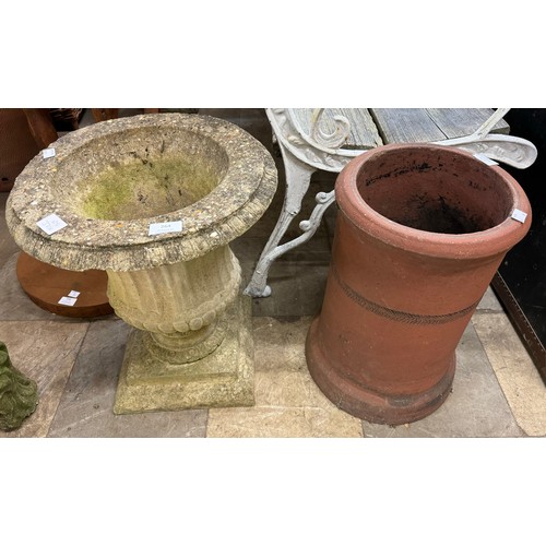 264 - A concrete campana shaped garden urn on stand and a terracotta chimney-pot