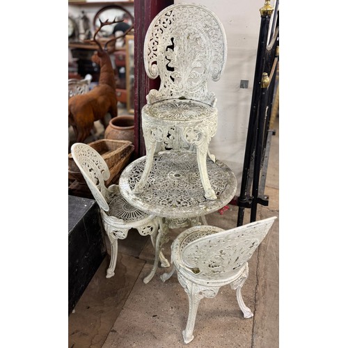 275 - A painted cast alloy garden table and chairs