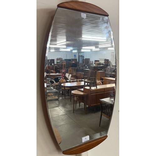 68 - A teak framed oval mirror