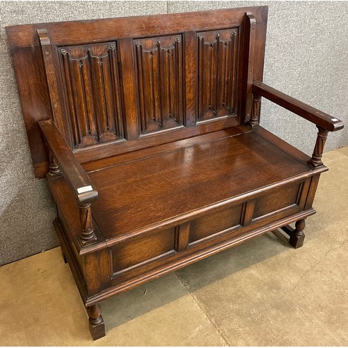 74 - An early 20th Century Waring & Gillow oak monks bench