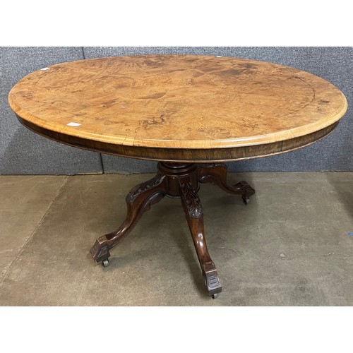 79 - A Victorian inlaid figured walnut oval tilt top breakfast table