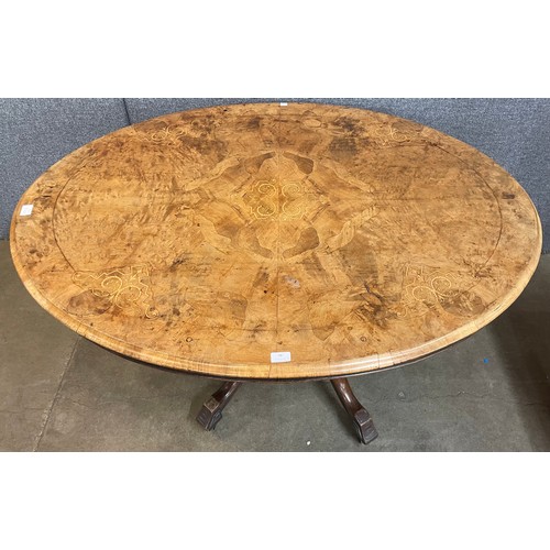 79 - A Victorian inlaid figured walnut oval tilt top breakfast table