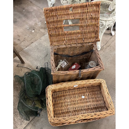 278 - A wicker fishing basket containing fishing equipment and two other wicker baskets