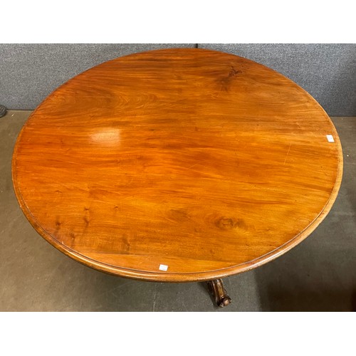 90 - A Victorian carved walnut circular tilt top breakfast table