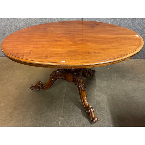 90 - A Victorian carved walnut circular tilt top breakfast table