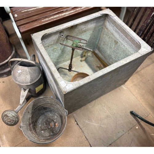 280 - A galvanised metal water trough, a watering can and bucket