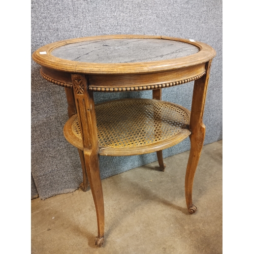 228A - A French oak, bergere and marble topped occasional table