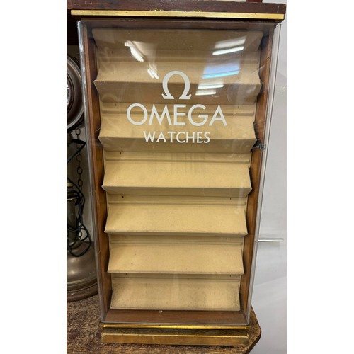 319 - An beech revolving watch display cabinet bearing Rolex and Omega inscription