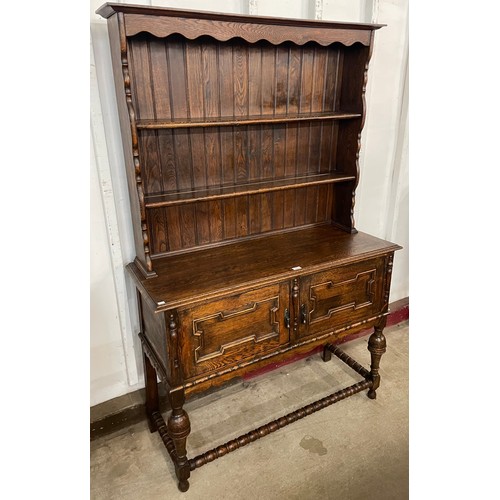 86 - An early 20th Century Jacobean Revival oak geometric moulded dresser