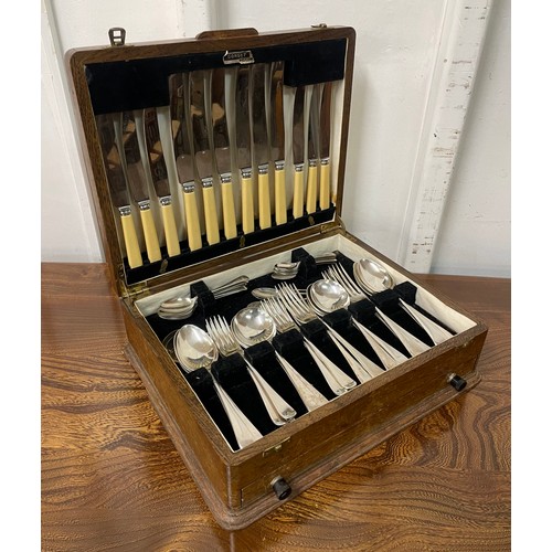 332 - An oak canteen of silver plated cutlery, with faux ivory handles