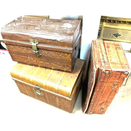 298 - Two early 20th Century tin steamer trunks and a leather suitcase