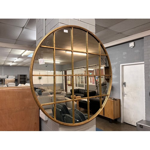 3063 - A circular gold mirror