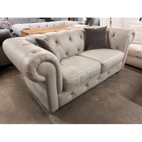 3040 - A stone leather Chesterfield 2.5 seater sofa