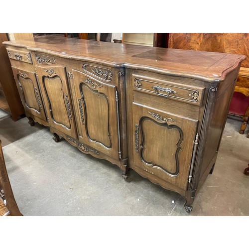 81 - An 18th Century style French Breton carved oak breakfront sideboard